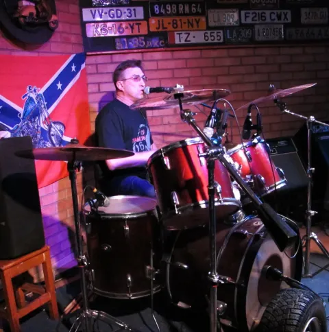 A musician at the keyboards on stage.