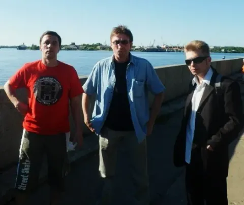 The musicians together outdoors.