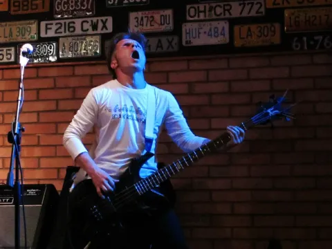 A musician at the microphone on stage.