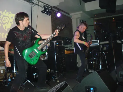 Guitarist and vocalist on stage.